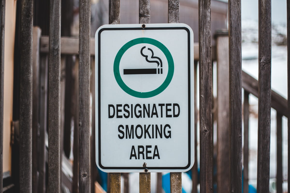 Designated Smoking Area sign nailed to wooden railings