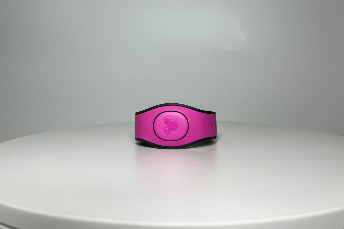 Pink Disney Magicband on a white table