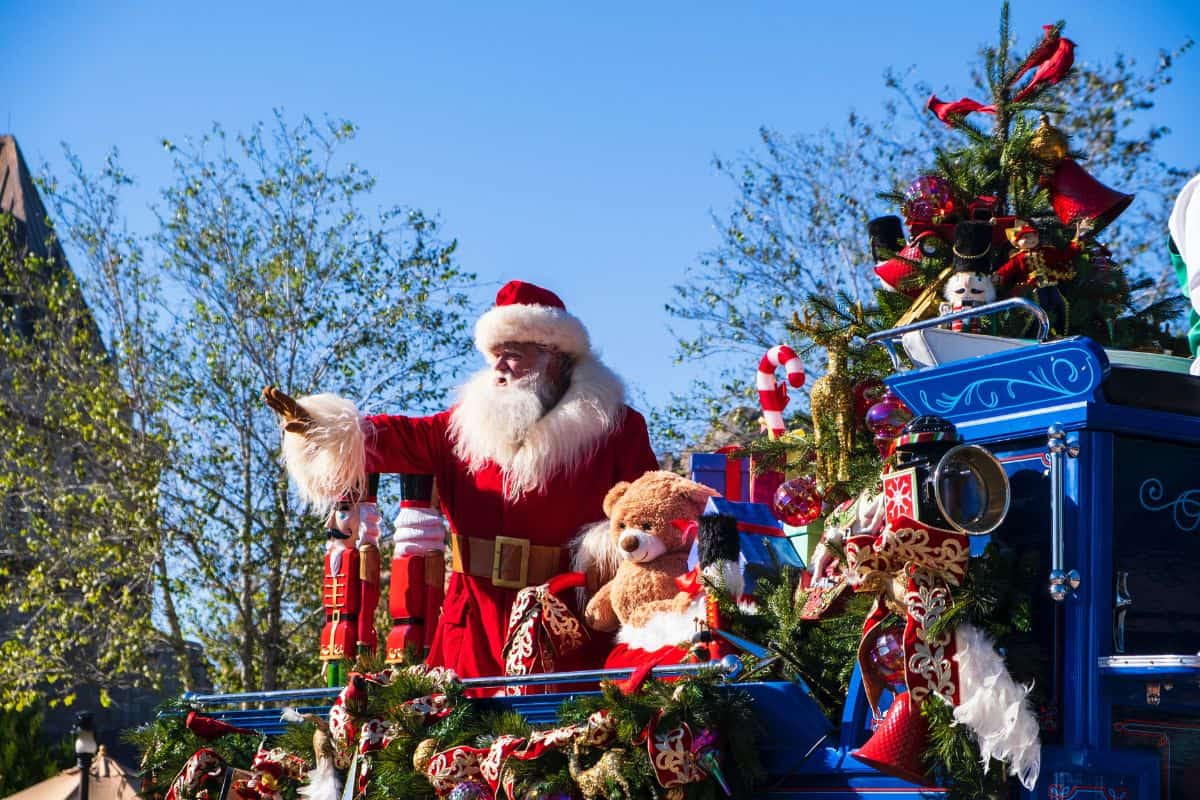 Man in a Santa Claus costume participating in a parade at Disney World