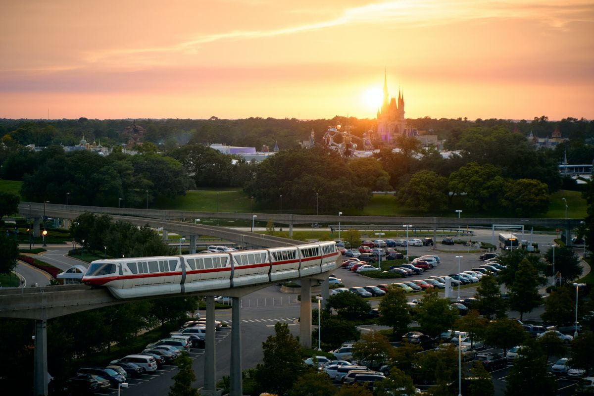 Aerial view of Disney World's parking area with a shuttle during sunset