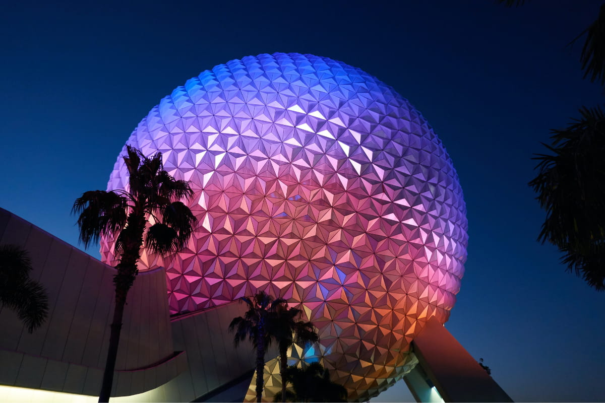 View from the ground looking up at the EPCOT's Spaceship Earth at nighttime.