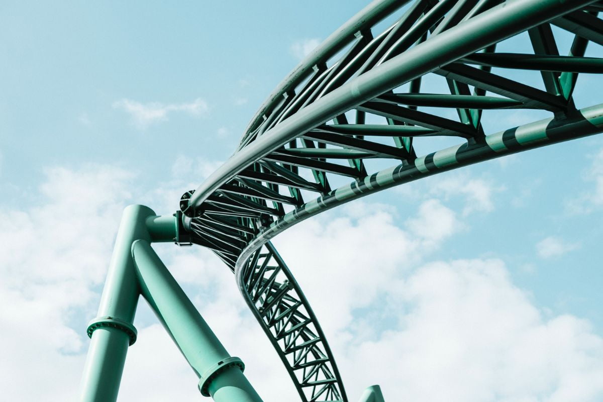 Close-up photo of green roller coaster tracks