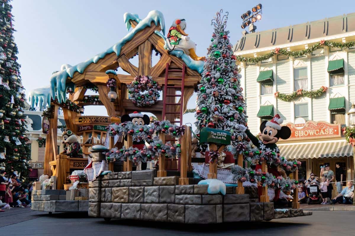 Disney mascots putting up Christmas decorations