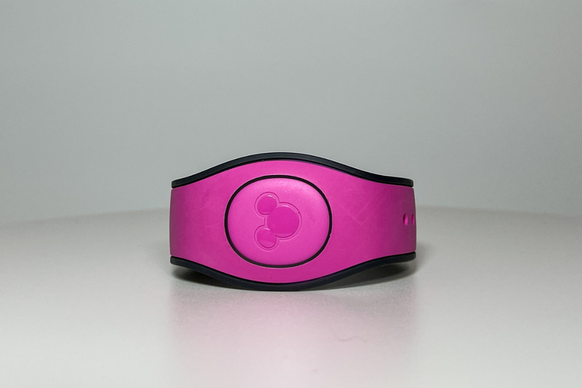 Pink Disney Magic Band on a white table