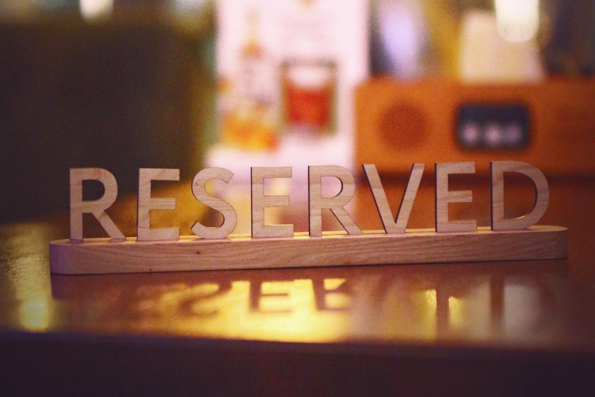 Dining table with a reserved sign