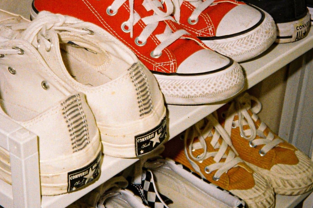 Multiple sneakers arranged on a shoe rack