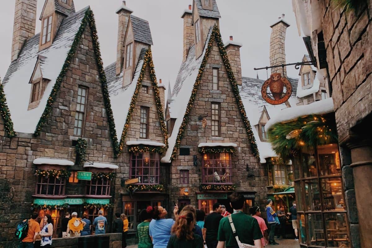 People walking outside the shops in Hogsmeade in the Wizarding World of Harry Potter