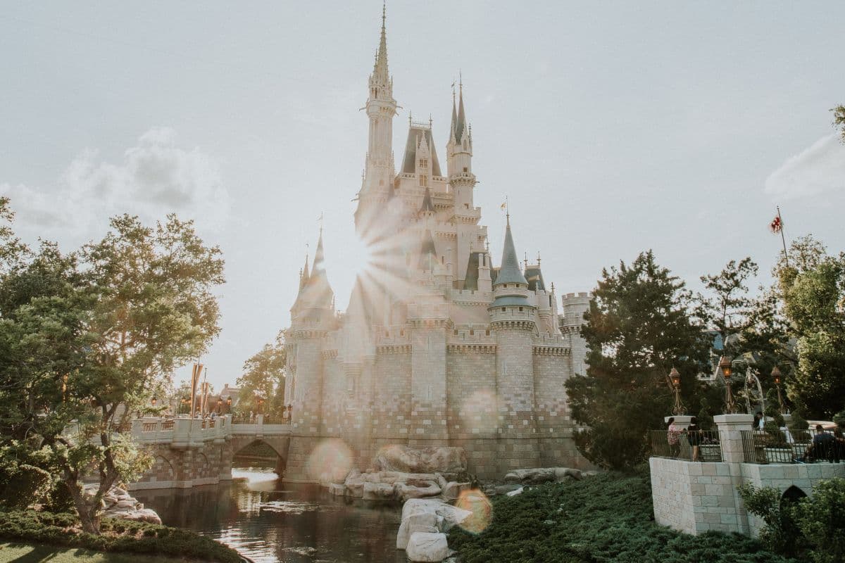 Sun peeking behind the castle at Magic Kingdom in Disney World Orlando