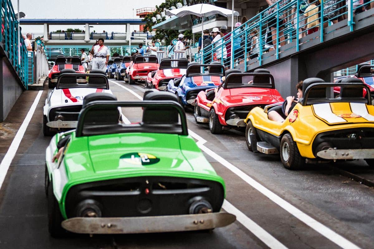 Multiple colorful cars at Tomorrowland Speedway in Disney World Orlando