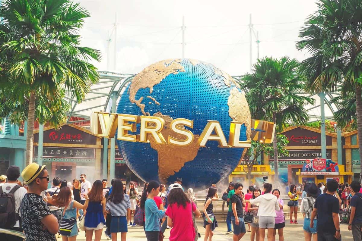 Multiple people gathered around the Universal Studios Globe