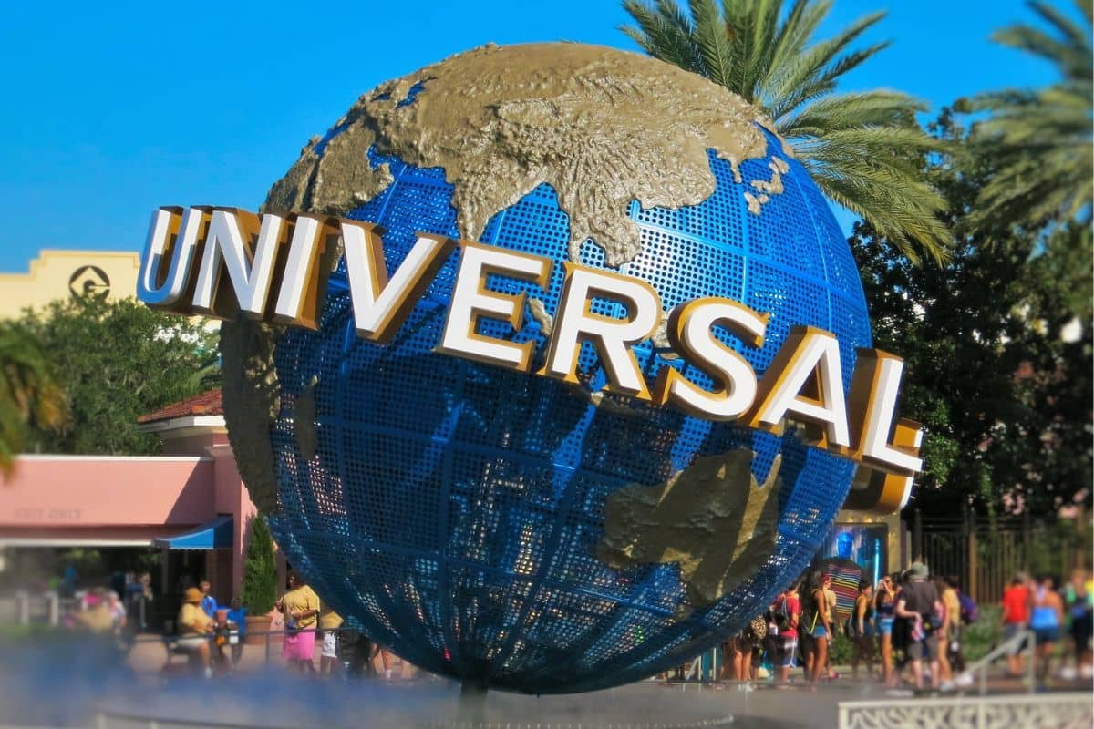 Close up of the Universal Studios Globe with a crowd of people in the background