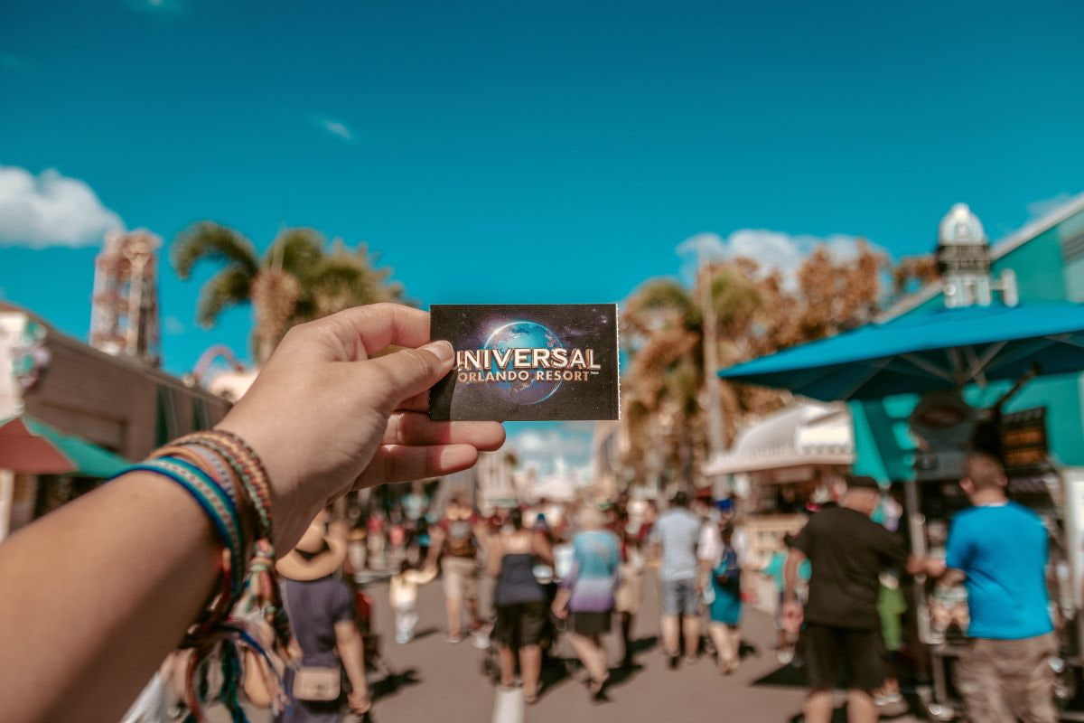 Person holding a Universal Studios ticket with the park as background