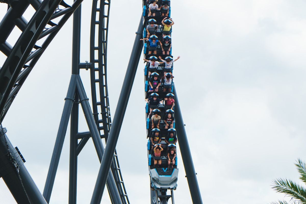 People riding the VelociCoaster going through a steep drop
