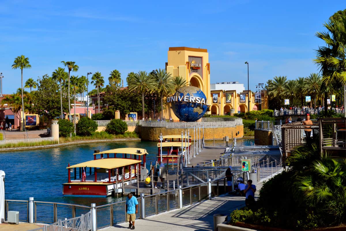 Four Universal Water Taxis by the dock near the Universal Globe and entrance
