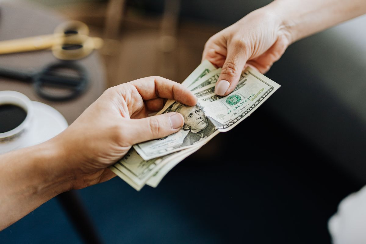 Two people performing a cash transaction