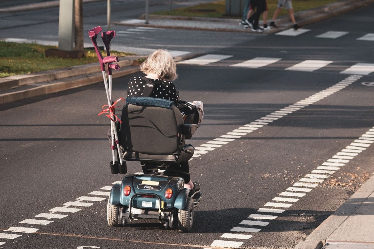 Person riding an ECV or electric conveyance vehicle along the street