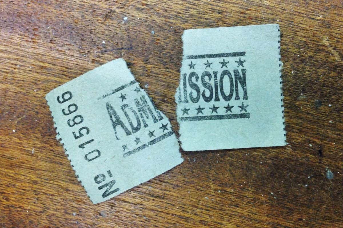 Close up photo of a ticket that has been ripped in half on a wooden surface