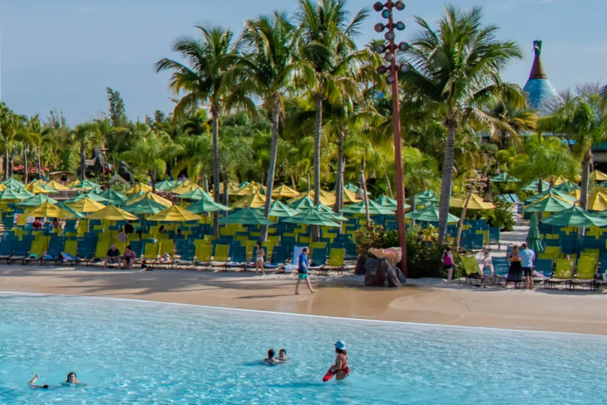 Umbrellas and lounge chairs by the beach at Volcano Bay in Universal Orlando