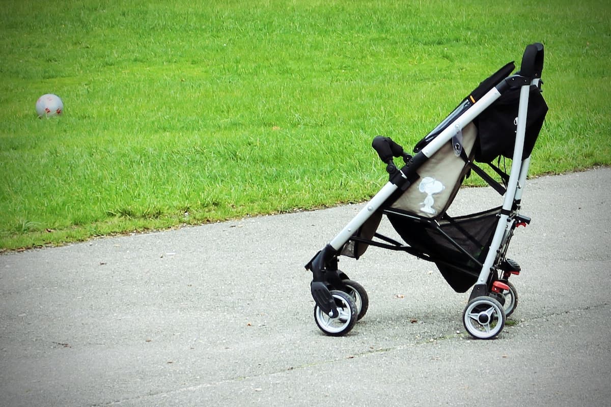 A black stroller in the park. 