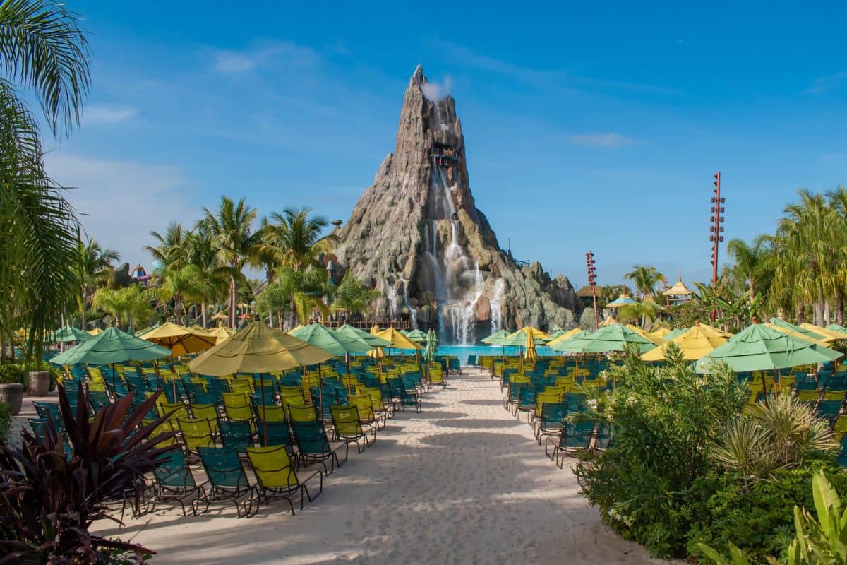 Lounge chairs under umbrellas facing the Krakatau volcano at Volcano Bay in Universal Orlando