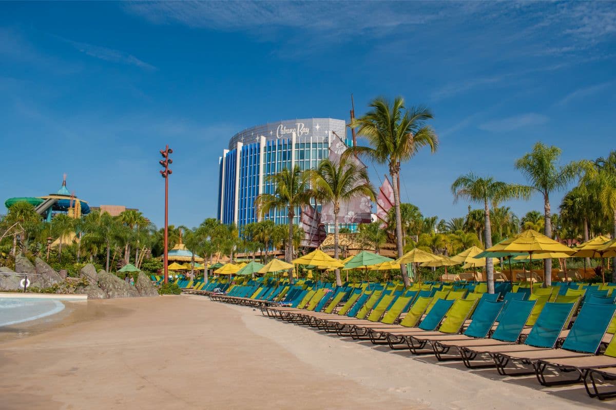 Lounge chairs and umbrellas by the beach at Volcano Bay in Universal Orlando