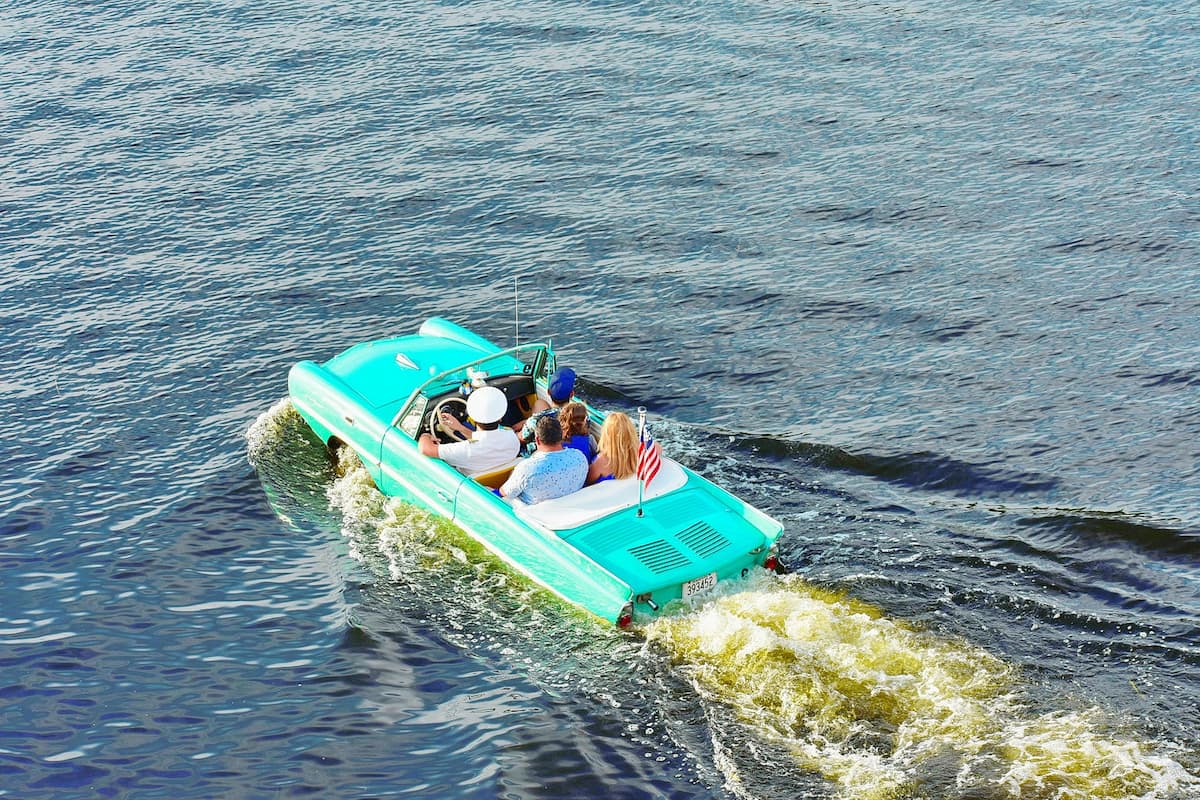 People enjoying the vintage amphicar tour in Lake Buena Vista at Disney Springs.