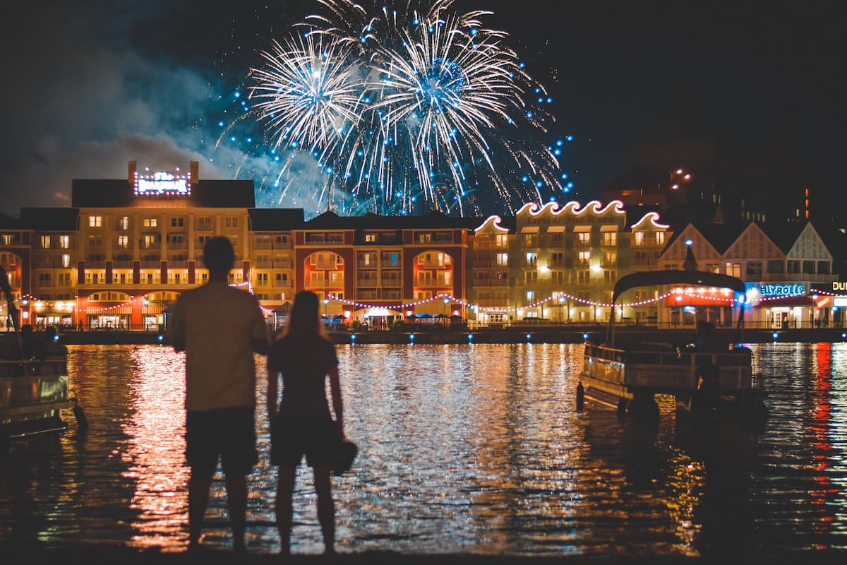 Two people standing while watching the fireworks show at Disney's Boardwalk Inn. 