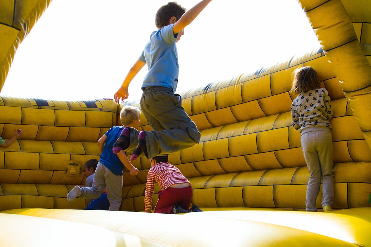 Children are playing in an inflatable castle.