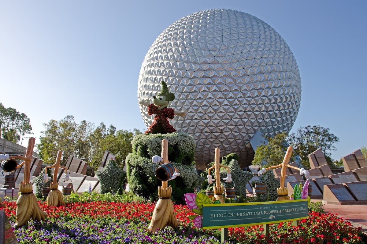 Photo of the Spaceship Earth and Mickey Mouse topiary at the entrance of EPCOT International Flower & Garden Festival.