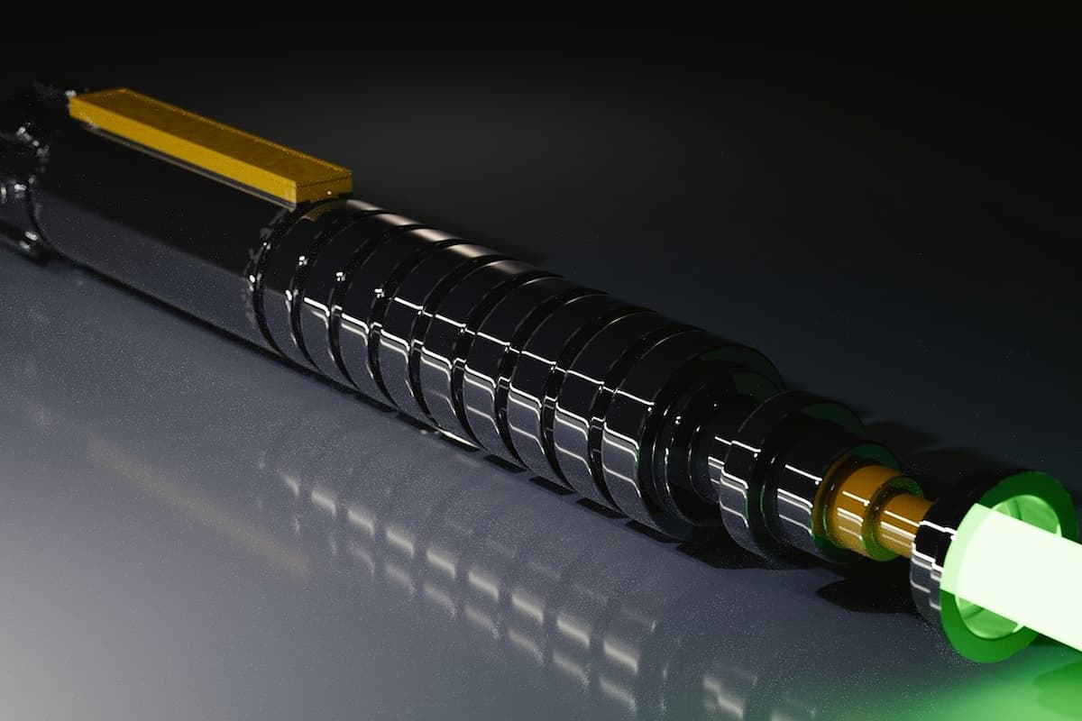 Close-up photo of a lightsaber on a gray surface. 