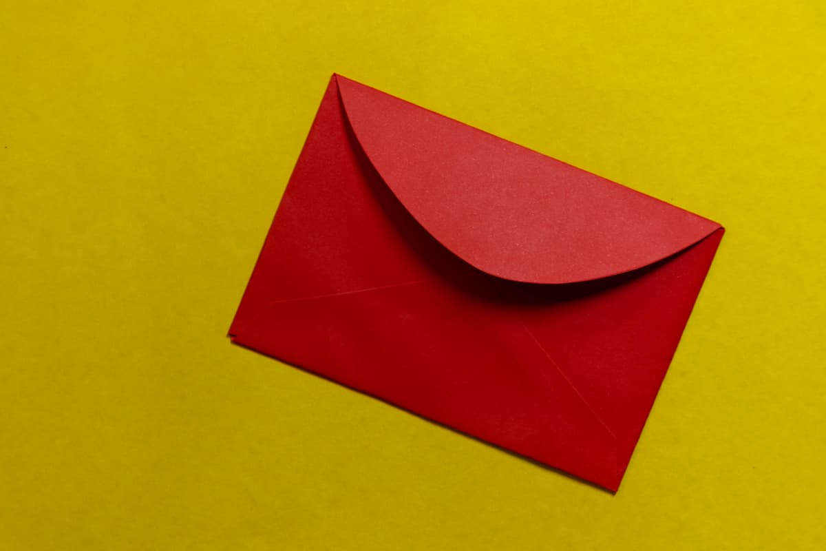 A red envelope on a yellow surface.