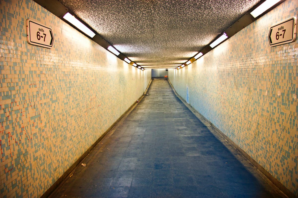 Photo of a tunnel with exits 6-7 written on the walls. 