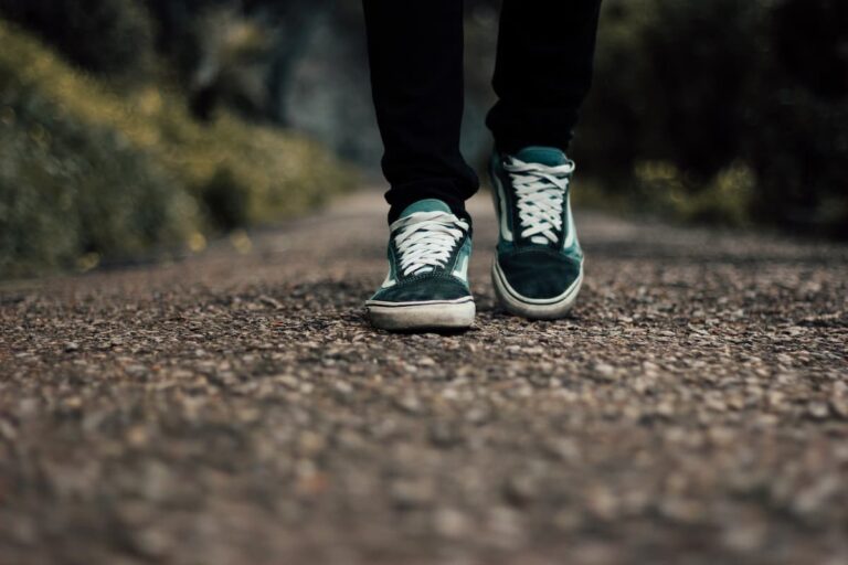 A person in green shoes is walking.