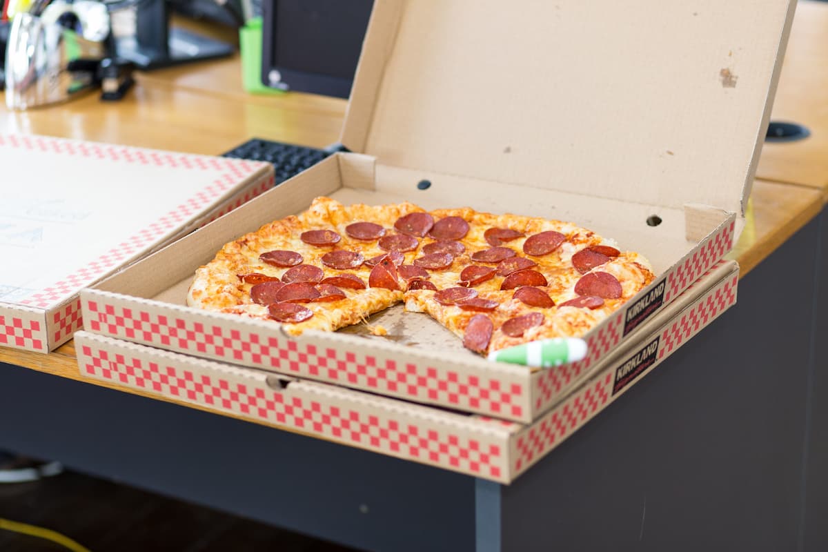 Pizza in a box on the table.